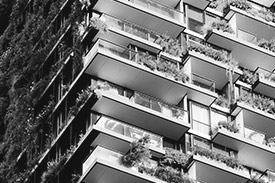 Exterior view of an apartment building, looking up.